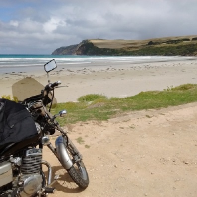 The motorcycle on a sandy beach road at Bridgewater Blowholes in soutn Australia.